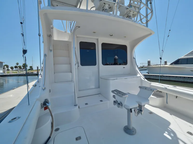 Slide: The Image of 2005 Luhrs 41 Convertible yacht stern with fishing chair and ladder. - 45