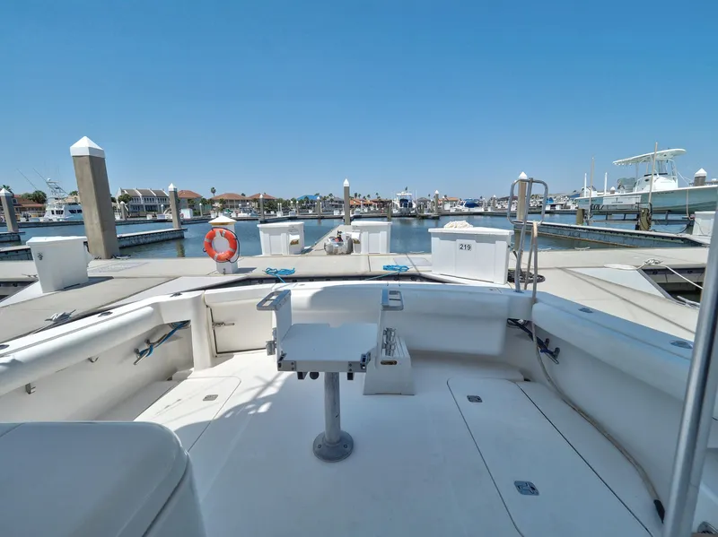 Slide: The Image of 2005 Luhrs 41 Convertible boat docked at a marina, spacious deck view. - 46