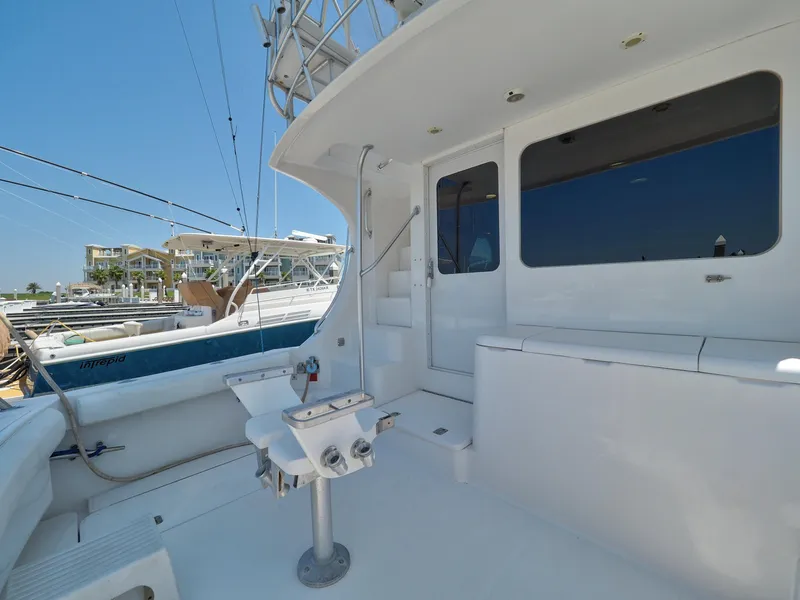 Slide: The Image of 2005 Luhrs 41 Convertible yacht deck with fishing chair and marina view. - 47