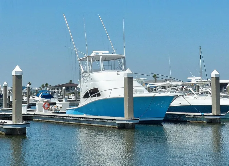 Slide: The Image of 2005 Luhrs 41 Convertible yacht docked at a marina on a sunny day. - 6
