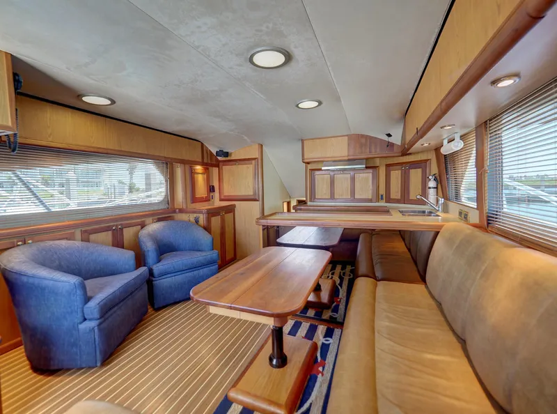 Slide: The Image of Interior of 2005 Luhrs 41 Convertible yacht with cozy seating and wooden finishes. - 8