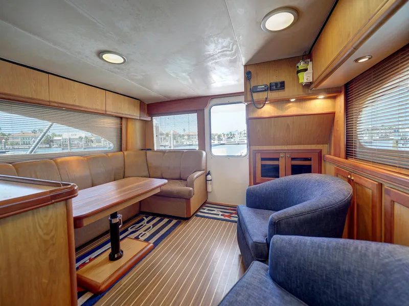 Slide: The Image of 2005 Luhrs 41 Convertible yacht interior with seating and wooden finishes. - 9