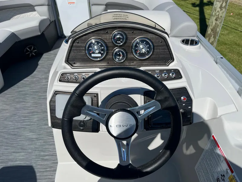 Slide: The Image of 2024 Lowe SS 170 boat dashboard with steering wheel and instrument panel. - 10