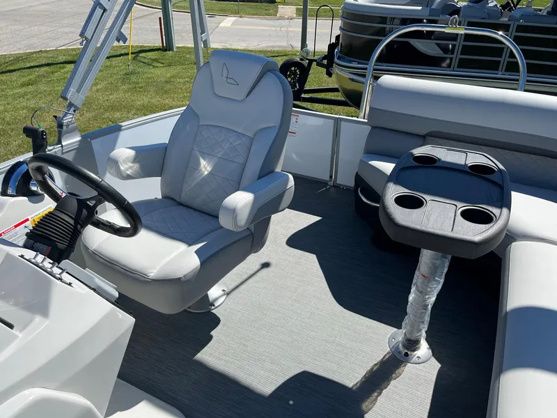 Slide: The Image of 2024 Lowe SS 170 boat interior with captain's chair and cupholder table. - 16
