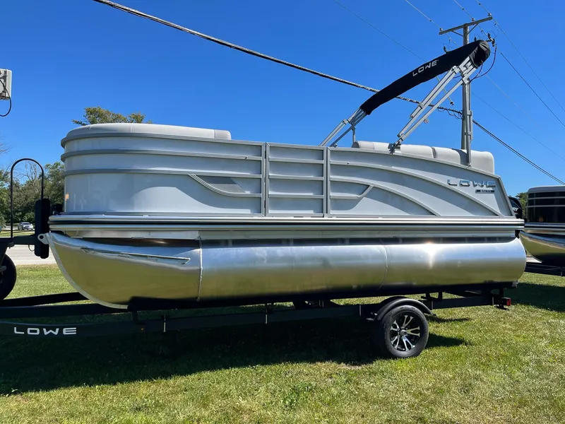 Slide: The Image of 2024 Lowe SS 170 pontoon boat on trailer, side view. - 3
