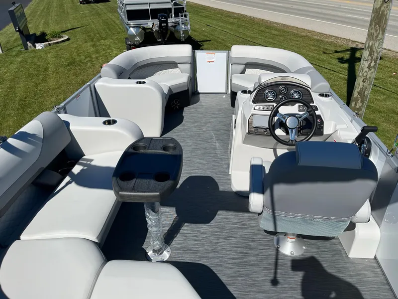Slide: The Image of 2024 Lowe SS 170 pontoon boat interior with seating and steering console. - 5