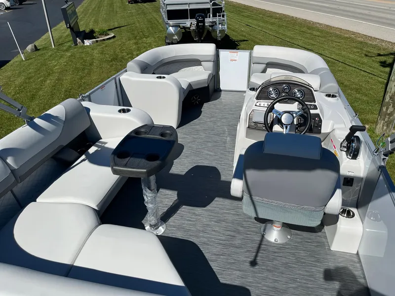 Slide: The Image of 2024 Lowe SS 170 pontoon boat interior with seating and steering console. - 6