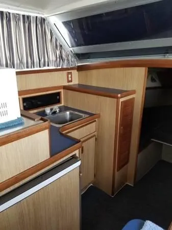 Slide: The Image of Interior of 1983 Bertram 28 boat with kitchenette and sleeping area. - 12