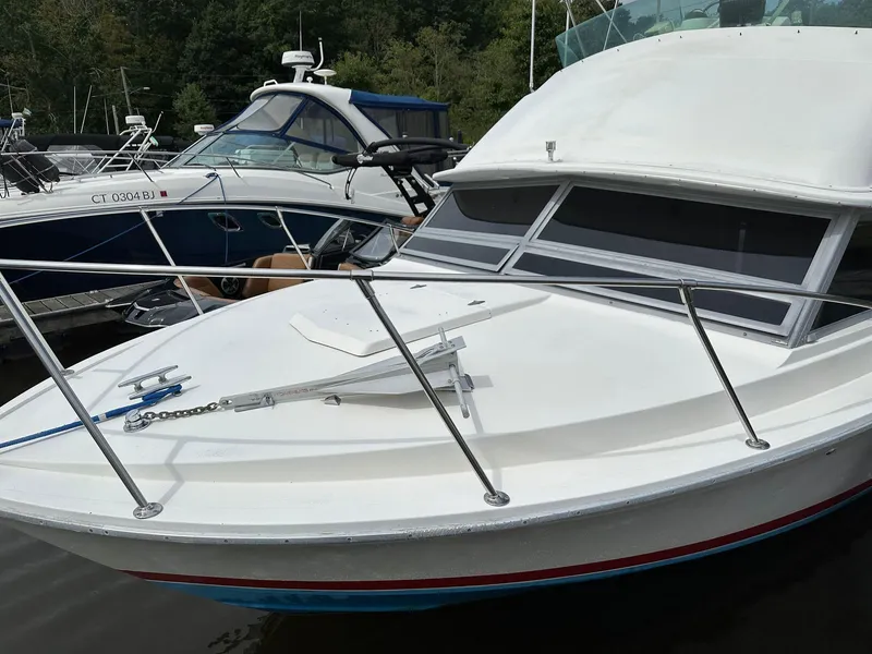 Slide: The Image of 1983 Bertram 28 boat docked at a marina, front view. - 17