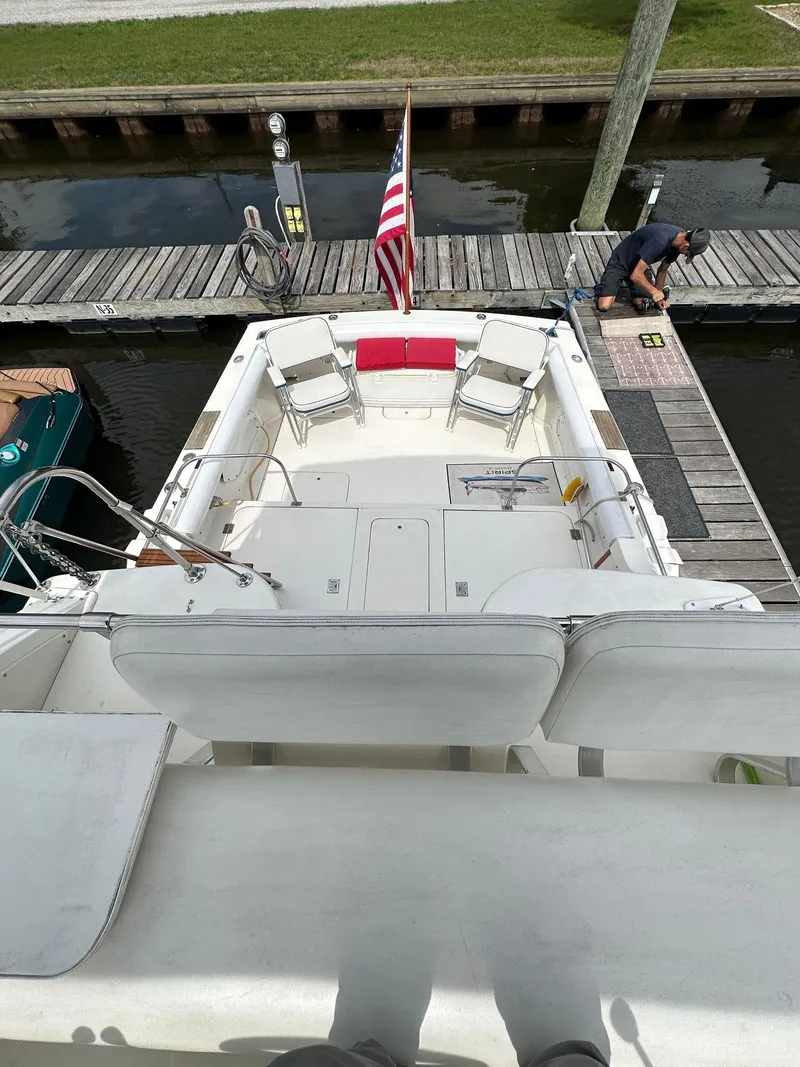 Slide: The Image of 1983 Bertram 28 boat docked, view of the deck and seating area. - 18