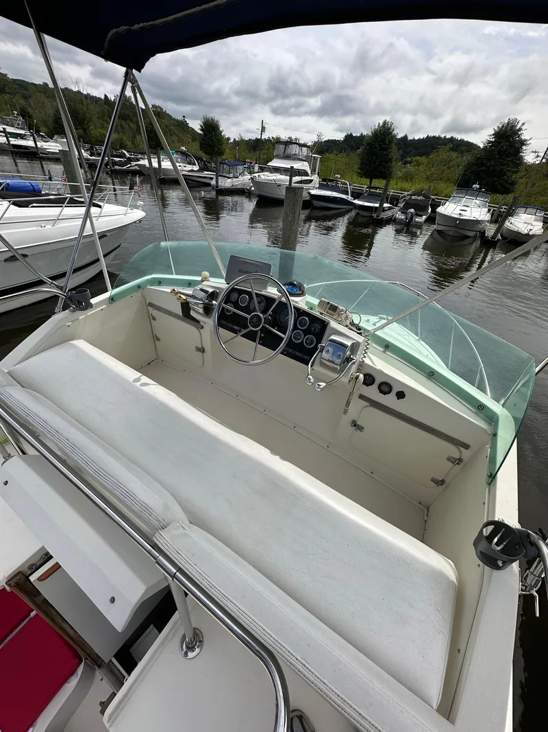 Slide: The Image of Cockpit view of a 1983 Bertram 28 boat docked at a marina. - 20