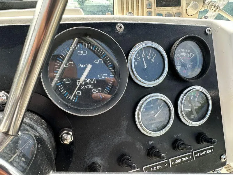 Slide: The Image of Dashboard of a 1983 Bertram 28 boat with gauges and controls. - 24