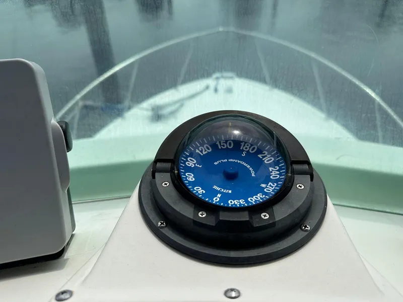 Slide: The Image of Compass on the dashboard of a 1983 Bertram 28 boat. - 26