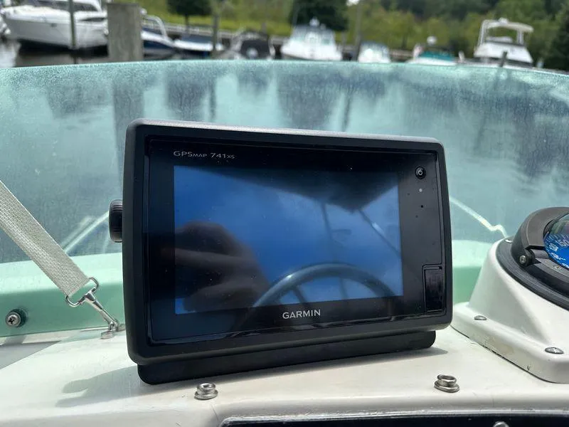 Slide: The Image of Garmin GPSmap 741xs on 1983 Bertram 28 boat dashboard, docked with other boats in background. - 27