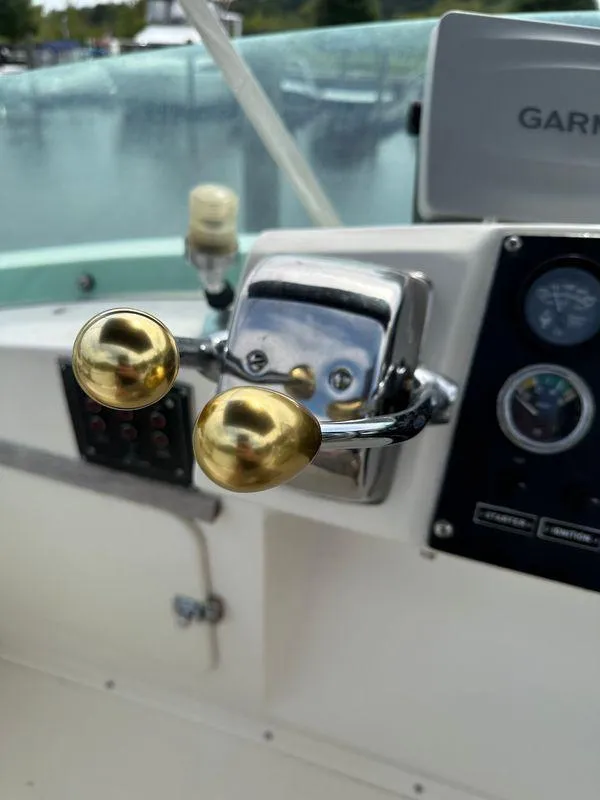 Slide: The Image of Close-up of 1983 Bertram 28 boat throttle controls and dashboard. - 28