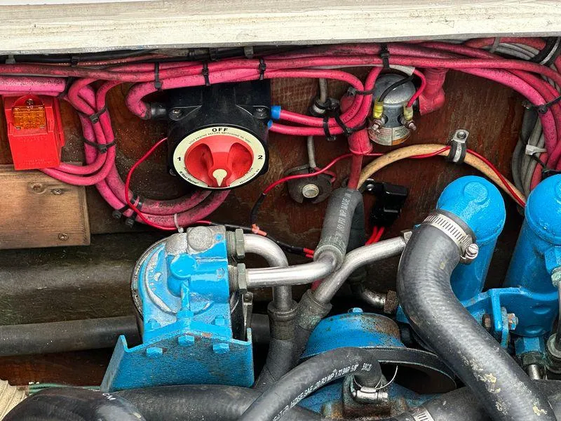 Slide: The Image of Engine compartment of a 1983 Bertram 28 boat with wiring and components. - 34