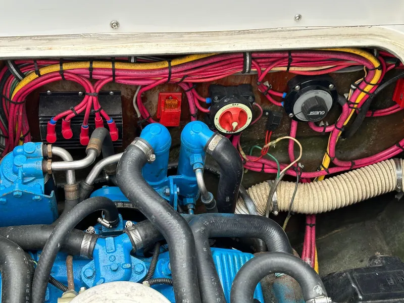 Slide: The Image of 1983 Bertram 28 engine compartment with wiring and hoses. - 35