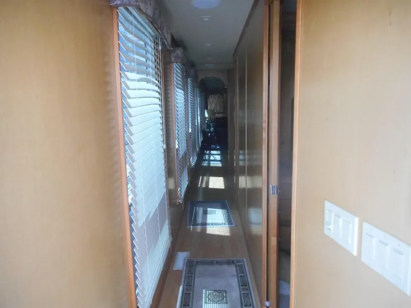 Slide: The Image of Narrow hallway in 2004 Sharpe Mysterious Waves houseboat with wooden walls and blinds. - 17