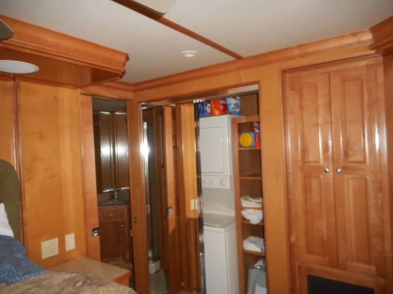 Slide: The Image of Interior of 2004 Sharpe Mysterious Waves with wooden cabinets and laundry area. - 18
