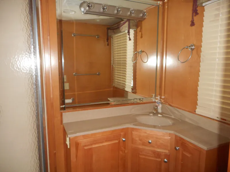 Slide: The Image of Luxurious wooden bathroom interior with mirror, sink, and blinds in a 2004 Sharpe Mysterious Waves. - 19
