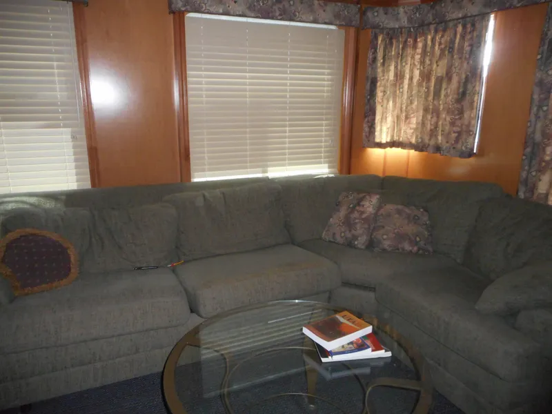 Slide: The Image of Cozy living room with green sectional sofa, glass coffee table, and floral curtains in a Sharpe Mysterious Waves. - 35