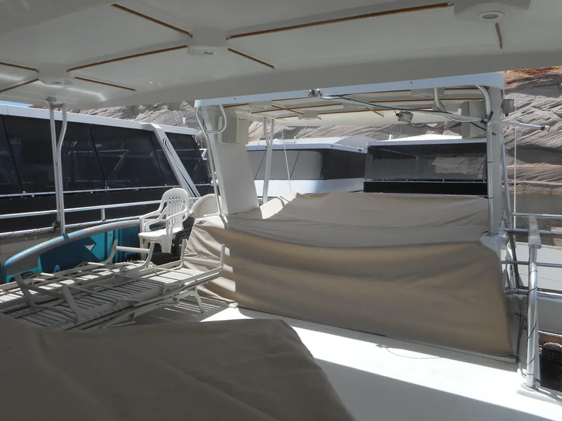 Slide: The Image of Deck view of 2004 Sharpe Mysterious Waves yacht with covered seating and lounge chairs. - 7