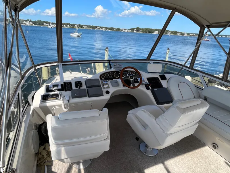 Slide: The Image of 1997 Sea Ray 420 Aft Cabin helm with panoramic water view. - 13