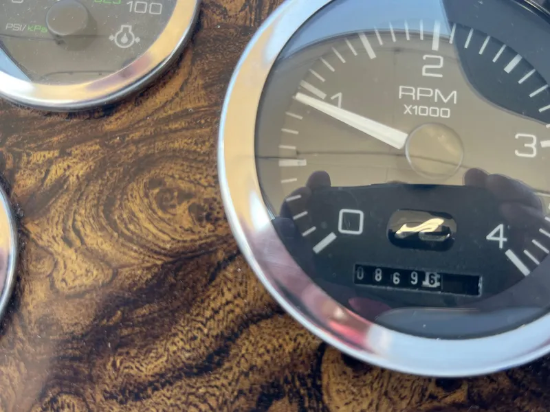 Slide: The Image of Dashboard of a 1997 Sea Ray 420 Aft Cabin with gauges and a motivational plaque. - 17