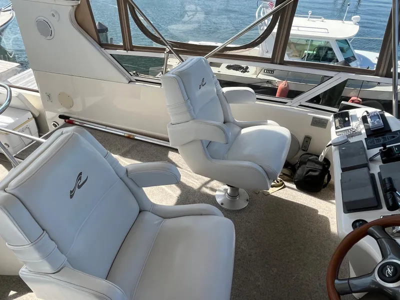 Slide: The Image of Interior of 1997 Sea Ray 420 Aft Cabin yacht with white captain chairs. - 19