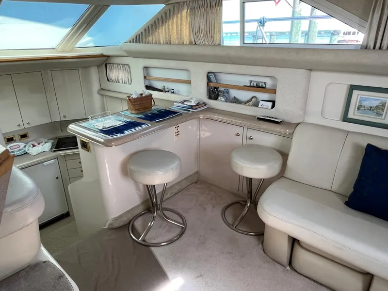 Slide: The Image of Interior of 1997 Sea Ray 420 Aft Cabin yacht with seating and bar stools. - 24