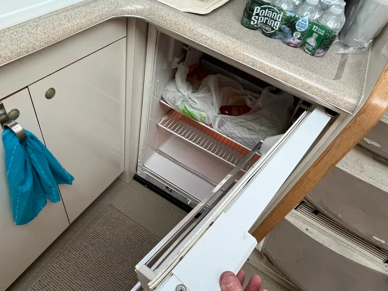 Slide: The Image of 1997 Sea Ray 420 Aft Cabin kitchen with open refrigerator and countertop. - 29