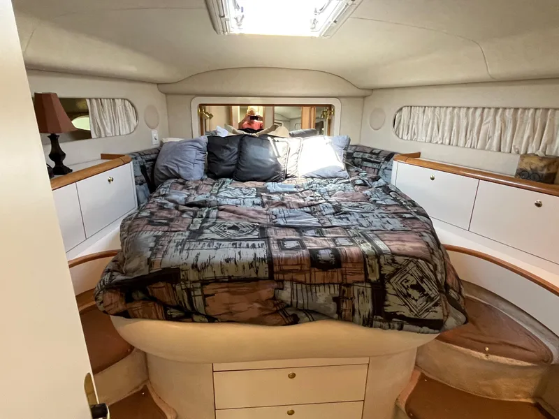 Slide: The Image of 1997 Sea Ray 420 Aft Cabin bedroom with cozy bed and ample storage. - 32