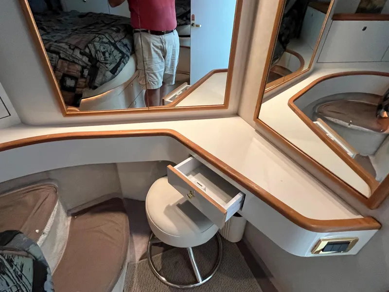 Slide: The Image of 1997 Sea Ray 420 Aft Cabin interior vanity with mirrors and stool. - 38