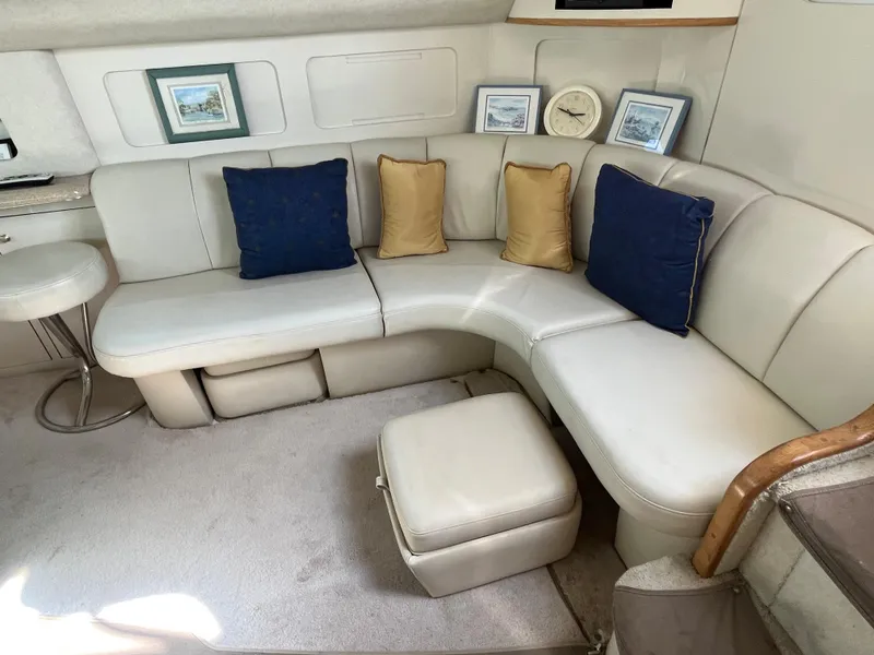 Slide: The Image of 1997 Sea Ray 420 Aft Cabin interior with white leather seating and decorative pillows. - 41