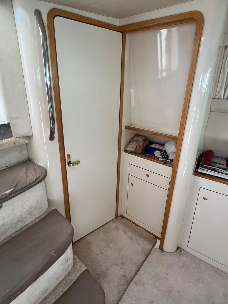 Slide: The Image of Interior of 1997 Sea Ray 420 Aft Cabin with stairs, door, and storage cabinets. - 42