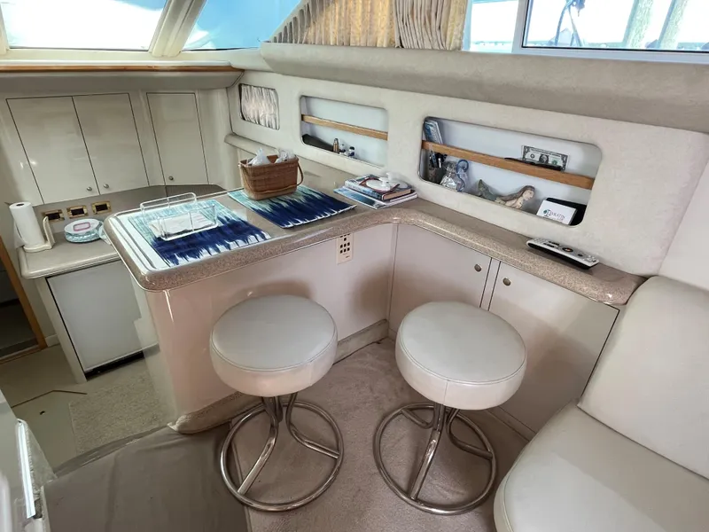 Slide: The Image of 1997 Sea Ray 420 Aft Cabin interior with bar stools and counter space. - 47