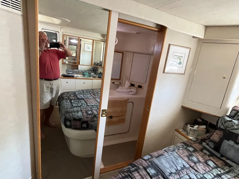 Slide: The Image of Interior of 1997 Sea Ray 420 Aft Cabin with mirrored closet and twin beds. - 48