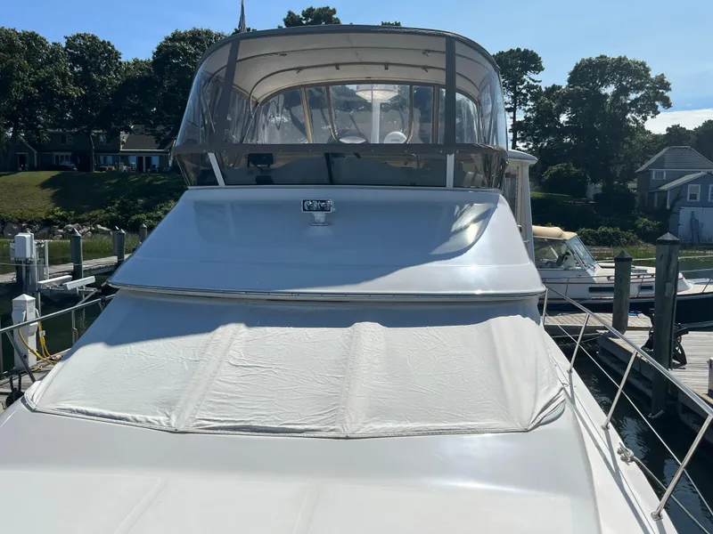 Slide: The Image of 1997 Sea Ray 420 Aft Cabin yacht docked at a marina. - 6