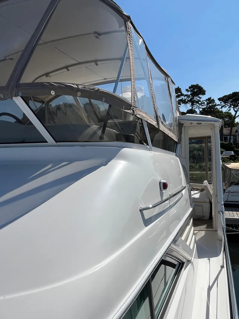 Slide: The Image of 1997 Sea Ray 420 Aft Cabin yacht with enclosed flybridge, docked at marina. - 8