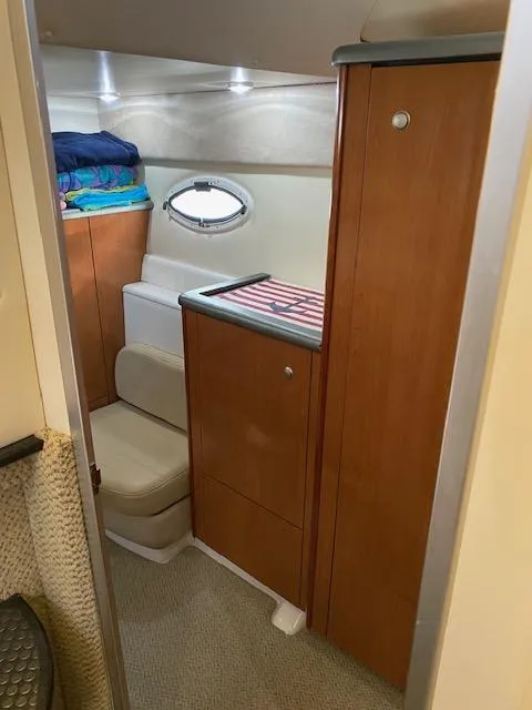 Slide: The Image of 2005 Maxum 3500 SY boat interior with wooden cabinets and seating. - 12