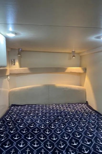 Slide: The Image of 2005 Maxum 3500 SY cabin interior with anchor-patterned bedding. - 14
