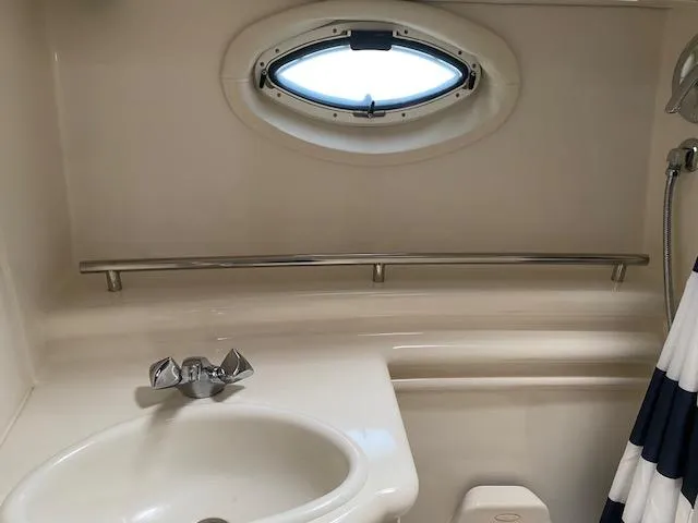 Slide: The Image of 2005 Maxum 3500 SY boat bathroom with sink and porthole window. - 20