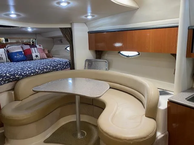 Slide: The Image of 2005 Maxum 3500 SY yacht interior with dining area and cozy sleeping quarters. - 9