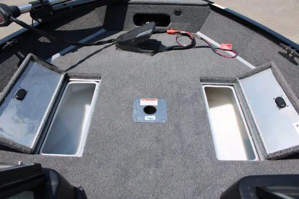 Slide: The Image of 2023 Lowe FM1675 boat interior with storage compartments and fishing rod holders. - 8