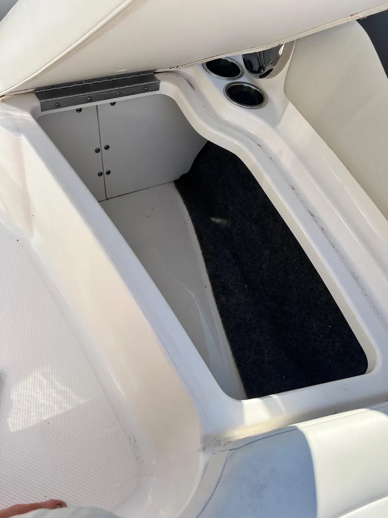 Slide: The Image of Open storage compartment in a 2013 Chaparral 246 SSi boat. - 10