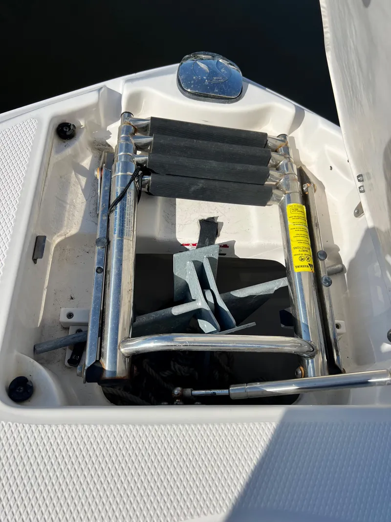 Slide: The Image of 2013 Chaparral 246 SSi boat with folded ladder and anchor storage. - 12