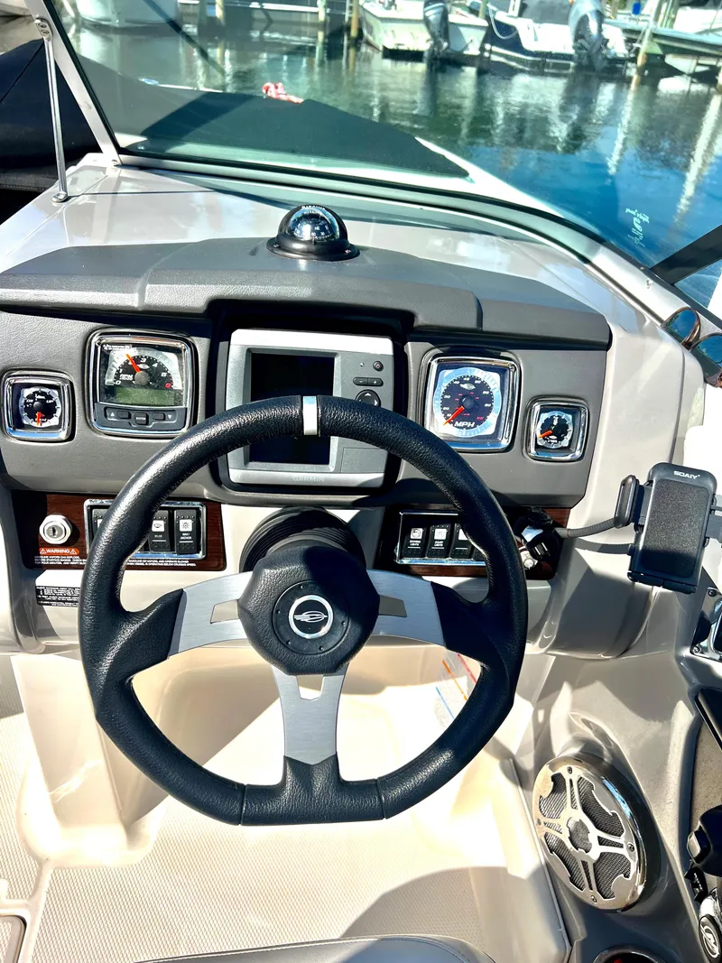 Slide: The Image of Steering console of a 2013 Chaparral 246 SSi boat with gauges and controls. - 2