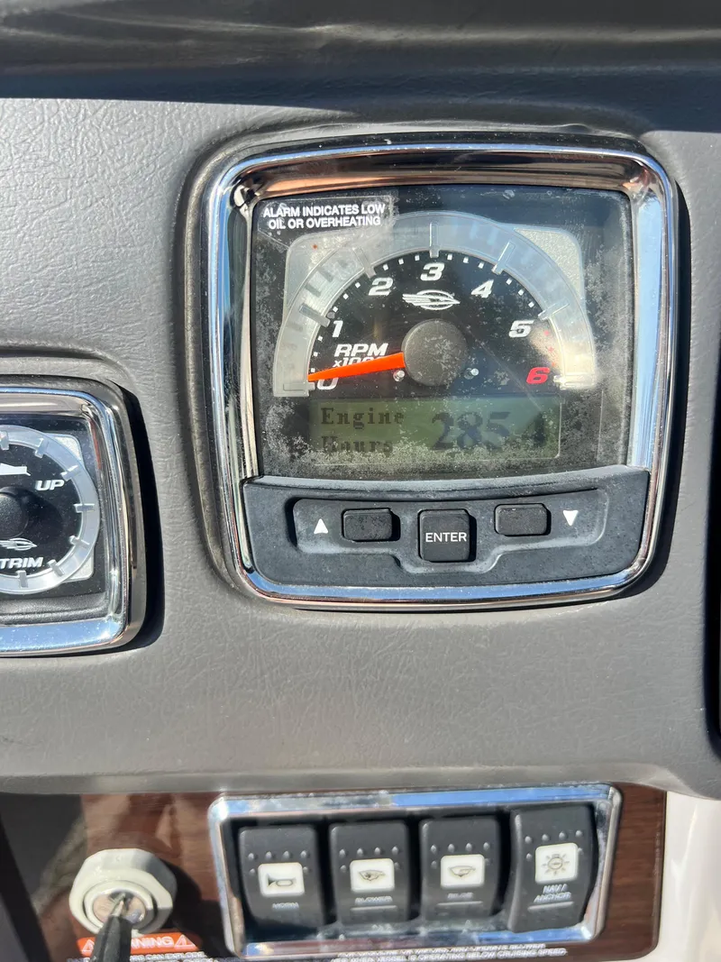 Slide: The Image of 2013 Chaparral 246 SSi boat dashboard with RPM gauge and controls. - 3