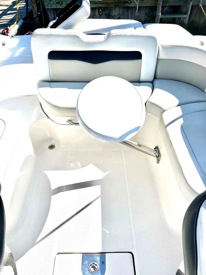 Slide: The Image of 2013 Chaparral 246 SSi boat interior with seating and table. - 7