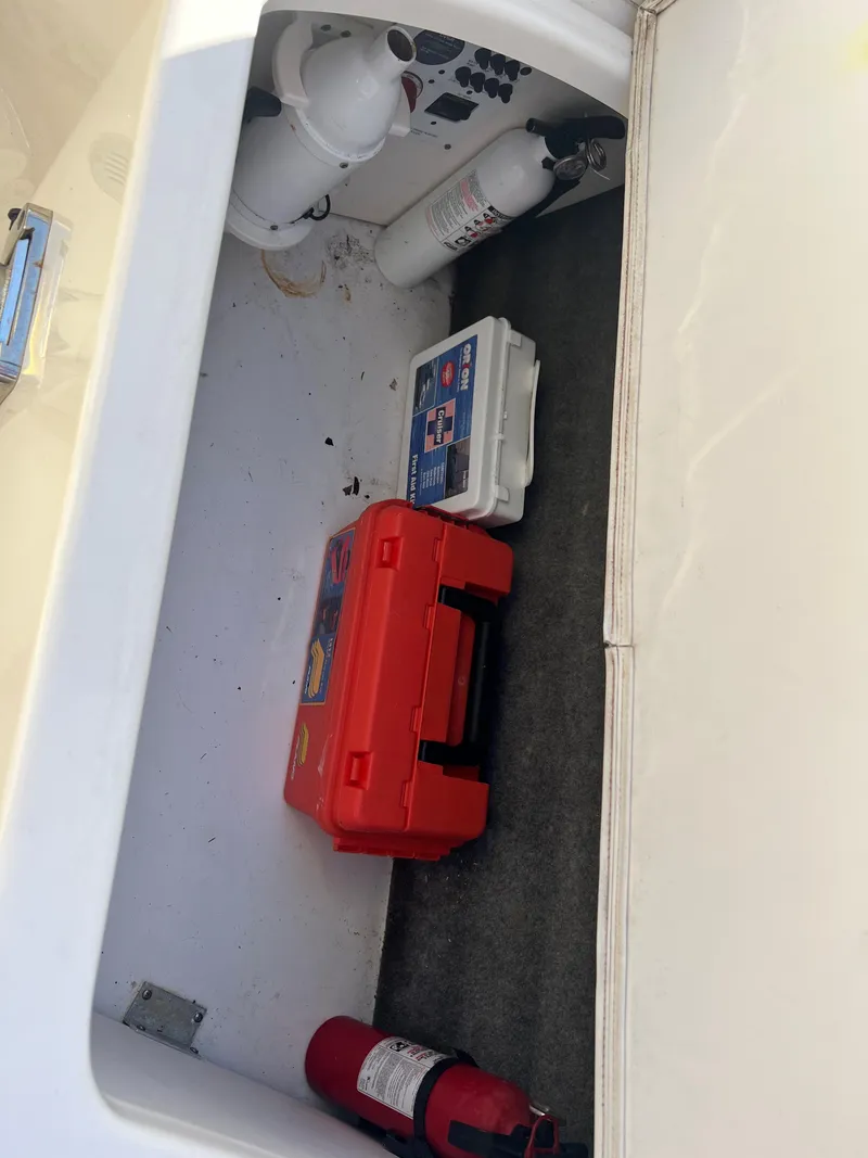 Slide: The Image of Storage compartment of a 2013 Chaparral 246 SSi boat with safety equipment. - 8